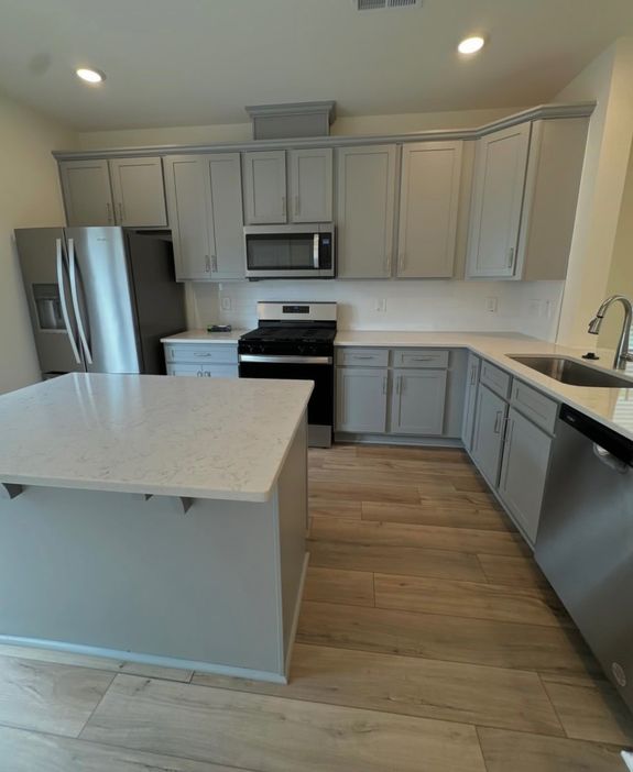 Crop housewife cleaning surface near sink