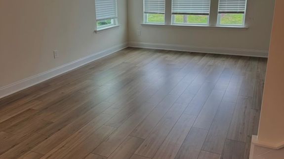 Person in Blue Gloves Cleaning White Sink