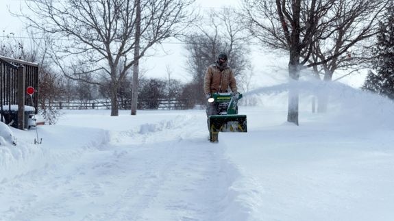 Close-up of hands sorting recyclable materials in clear plastic boxes indoors.