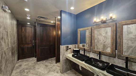 Man drilling wooden plank on desk