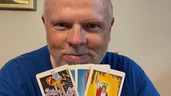 Kevin Coburn, Psychic Medium and Tarot Card Reader holding a deck of Tarot Cards