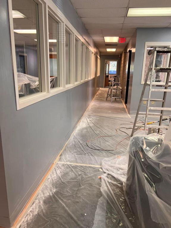 Painter with brush climbing ladder during renovation work