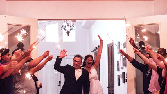 Portrait of a stylish young woman holding a vintage camera outdoors.