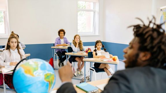 A Teacher Standing in the Classroom