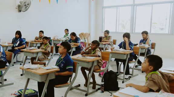 Woman Standing in Hallway While Holding Book