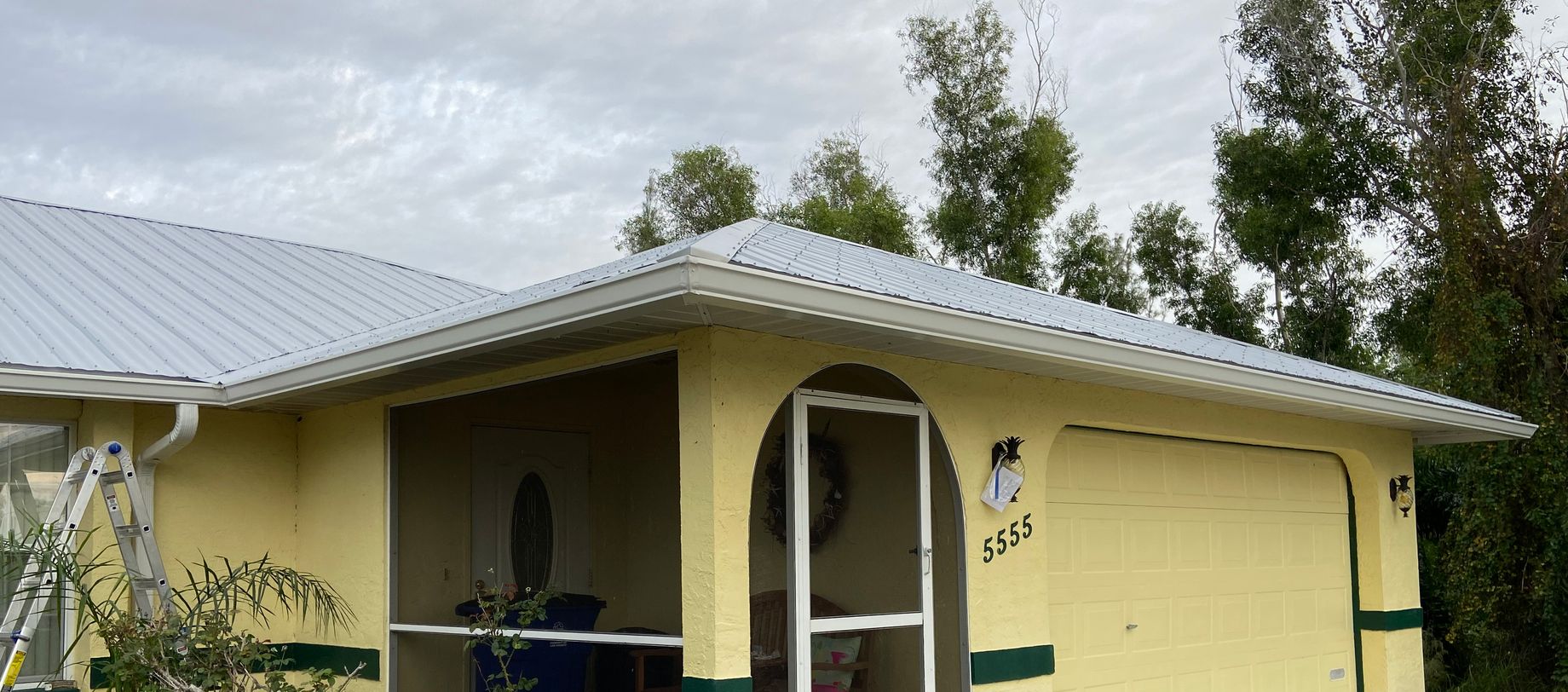 Yellow house with Pine Gutters installed by GSF