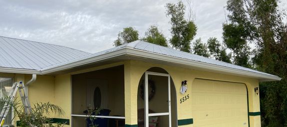 Yellow house with Pine Gutters installed by GSF