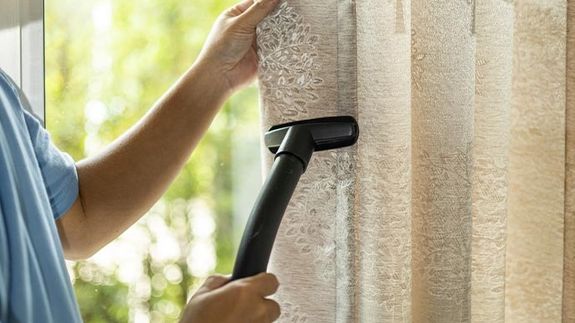 Woman Wearing Apron Cleaning Window Glass