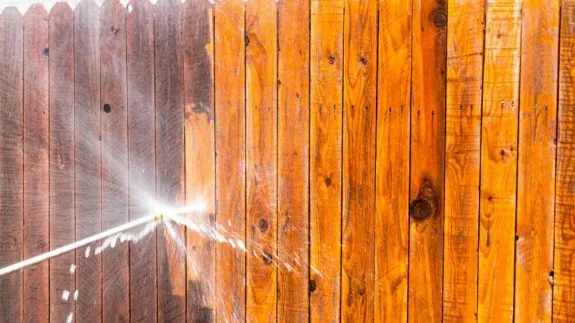 Concentrated man washing automobile at car wash