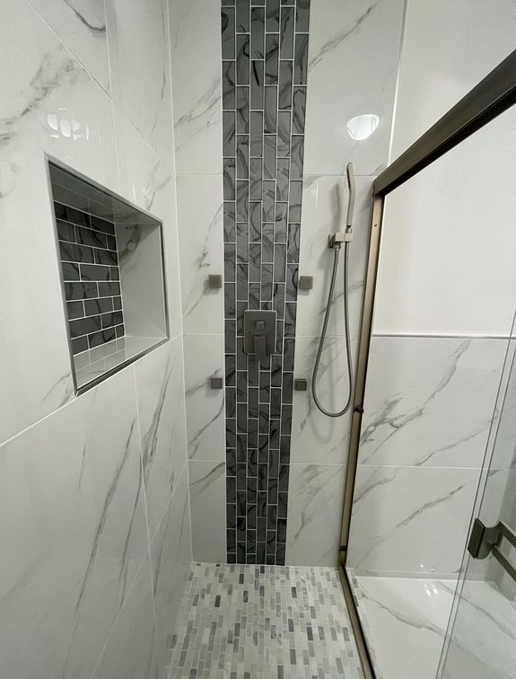 Interior of bathroom table with soap and cosmetic oil placed near white sink and faucet under mirror in wooden frame in modern apartment