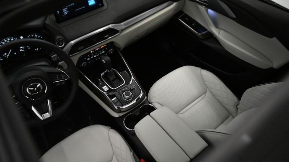 Closeup daytime running lights switched on of modern new polished luxury gray automobile