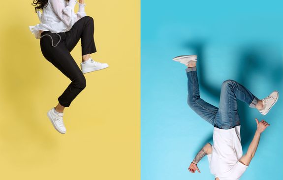 Casually-dressed young people jumping into the air wearing clean sneakers